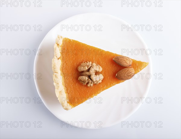 A slice of traditional american sweet pumpkin pie isolated on white background. top view