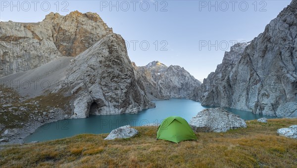 Wild camping, camping in the wilderness with a tent in front of mountain lake Kol Suu, Sary Beles