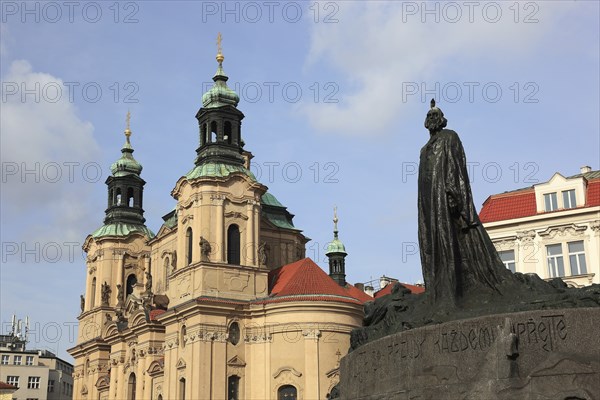Jan Hus Monument on Old Town Square and the baroque St Nicholas Church, Prague, Czech Republic,