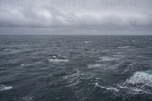 A stormy and turbulent sea under a cloudy grey sky, North Sea, Norway, Europe