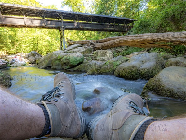 The Irrel Waterfalls, rapids in the lower reaches of the Prüm, covered wooden bridge for hikers,