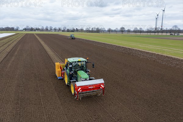 Lettuce plants are planted with a planting machine, tractor with roundabout harrow prepares the