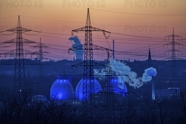 Digesters of the Emscher sewage treatment plant Bottrop, illuminated, high-voltage pylons, North