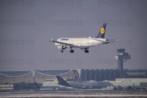 Lufthansa Airbus A320-200 approaching Frankfurt FRA airport, air traffic control tower, Fraport, in