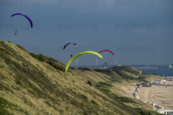 Paragliders along the dunes of Zoutelande, in Zeeland, South Holland, Netherlands
