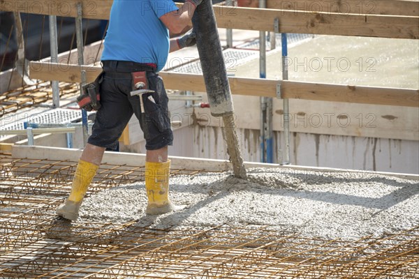 Construction site, concreting, the floor slab of a building is concreted, the concrete is pumped