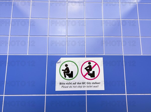 Sign in a public toilet, do not place on the toilet seat