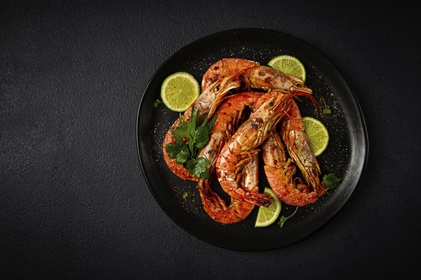 Langoustines, Australian, freshly frozen on ice, top view, lime and greens