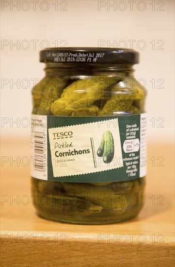 Glass jar of Tesco pickled Cornichons showing label, UK