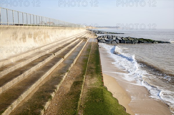 Curved Sea wall, steps and rock armour groynes, forming coastal defences at Southwold, Suffolk,