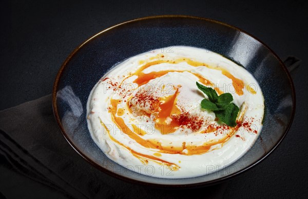 Cilbir, traditional Turkish breakfast, Turkish eggs with yogurt and butter, homemade, no people