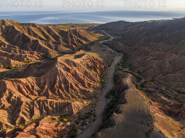 Aerial view, eroded mountain landscape, sandstone cliffs, canyon with red and orange rock