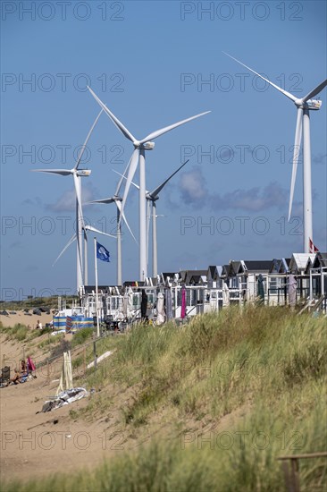 Wind turbines, wind farm, holiday homes, beach houses on the beach of Ijmuiden in North Holland,