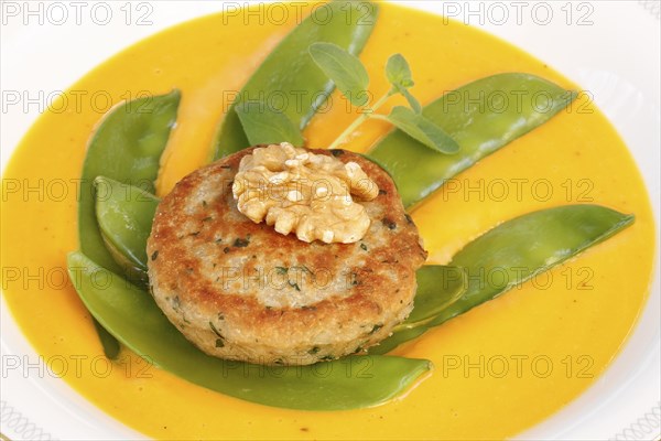 Vegetarian cuisine, walnut cakes on sugar snap peas with pumpkin sauce, sauce, vegetables, snow
