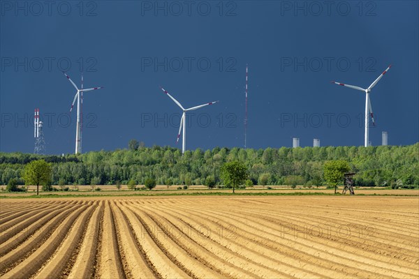 Wind turbines on the Grevenbroich wind test field, dark rain clouds, in the Rhenish lignite mining