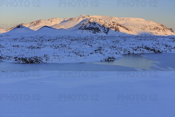 Morning light on a snowy lava field, lake, volcanic crater, snow, winter, Berserkjahraun,