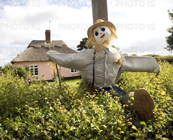 Scarecrow to advertise village garden open day event, Sutton, Suffolk, England, UK