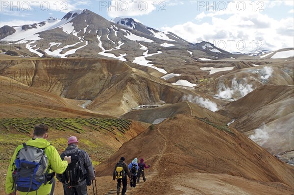 Hikers travelling in a desert-like, geothermally active mountain region, fire and ice,
