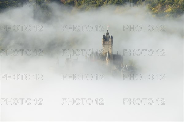 View of the Reichsburg castle near Cochem in dense fog, Moselle, Rhineland-Palatinate, Germany,