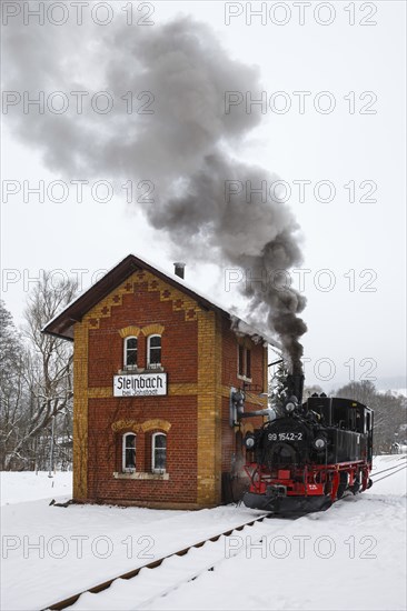 Steam train of the Preßnitztalbahn railway Steam locomotive in winter in Steinbach, Germany, Europe