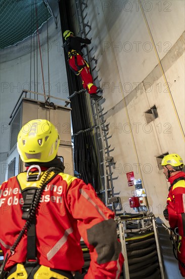 Height rescuers from the Oberhausen professional fire brigade practise abseiling from a wind