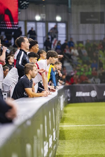 Football players sit on the bench and watch the game, Mercedes Benz Junior Cup, Glaspalast