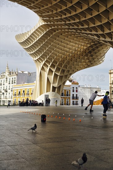 Inline skaters and pedestrians on the Plaza Mayor, Metropol Parasol, Seville, Andalusia, Spain,