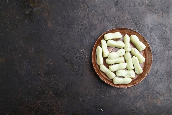 Jelly celery candies on black concrete background. copy space, top view, flat lay, close up