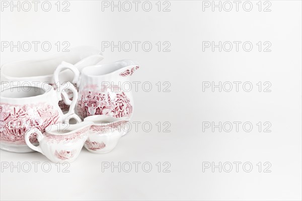White porcelain crockery with red details, white background, copy room