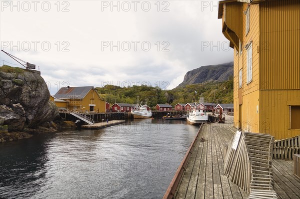 Historic buildings and fishing boats in the harbour of Nusfjord, Lofoten, Nordland, Norway, Europe