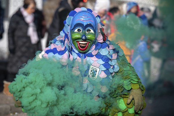 Hofener Scillamännle with smoke bomb at the big carnival parade, Hofen, Stuttgart,