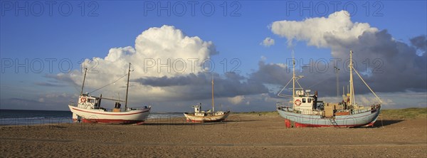 Summer clouds over fishing boats at the Slettestrand, Denmark, Europe
