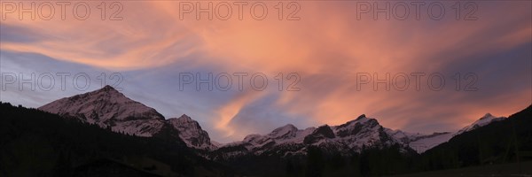 Colorful morning sky over a mountain range in Gsteig Bei Gstaad