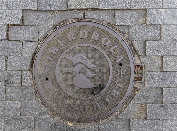 Madrid manhole cover on a busy street in Madrid, Spain, Europe