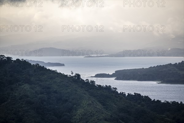 View to the sea over wooded hills, at sunset, cloud forest, Monte Verde, Puntarenas province, Costa