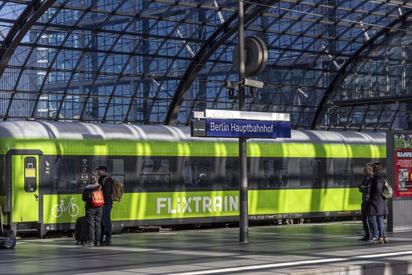 Central station, pillarless glass roof construction above the platforms, station sign and train of