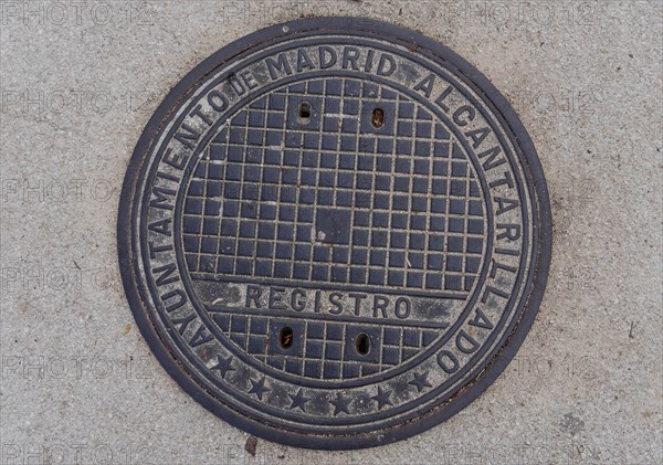 Madrid manhole cover on a busy street in Madrid, Spain, Europe