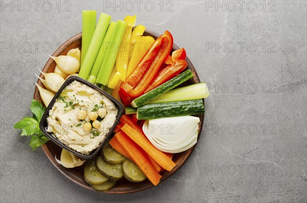 Flat lay view at vegetable Hummus dip dish topped with chickpeas and olive oil