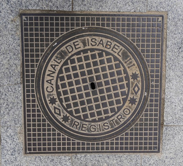 Madrid manhole cover on a busy street in Madrid, Spain, Europe