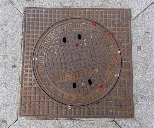 Madrid manhole cover on a busy street in Madrid, Spain, Europe