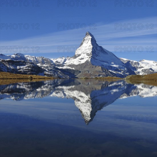Snow capped Matterhorn mirroring in lake Stellisee