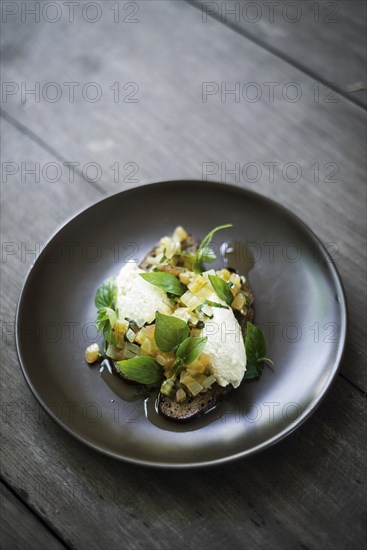 Ricotta cheese and salad with herbs on rye bread