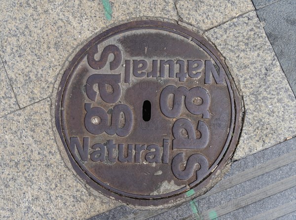 Madrid manhole cover on a busy street in Madrid, Spain, Europe