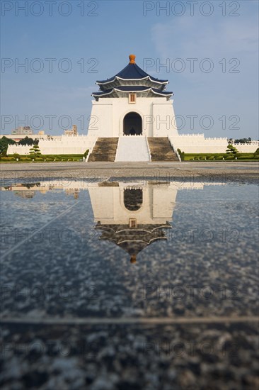 The Chiang Kai Shek Memorial Hall reflected in a puddle of rainwater