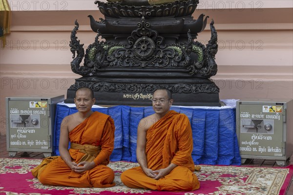Monks in front of a Buddha statue, Bhumispara-mudra, Buddha Gautama at the moment of enlightenment,