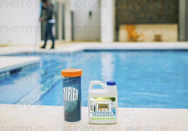 Clarifier for cleaning swimming pools. Clarifying chemical at the edge of a swimming pool