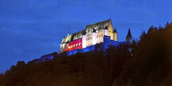 Vianden Castle, hilltop castle illuminated in the colours of the Luxembourg flag for the bank