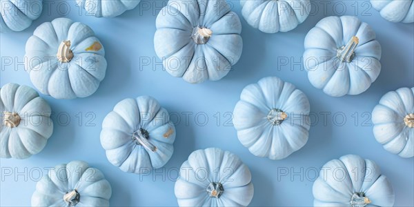Banner with small pastel blue decorative pumpkins on blue background. Generative Ai, AI generated