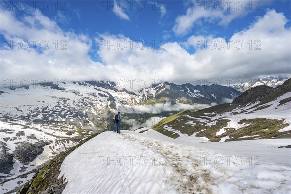 Mountaineer on hiking trail with snow, mountain landscape with summit Hoher Weißzint and