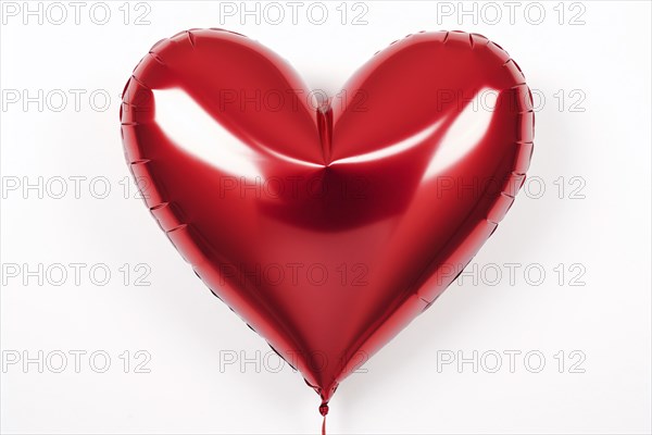 Red heart shaped foil balloon on white background. KI generiert, generiert, AI generated